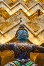 Statue of demon holding up the Golden chedi at the Wat Phra Kaew Palace, also known as the Emerald Buddha Temple. Bangkok, Thailan Royalty Free Stock Photo