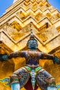 Statue of demon holding up the Golden chedi at the Wat Phra Kaew Palace, also known as the Emerald Buddha Temple. Bangkok, Thailan Royalty Free Stock Photo