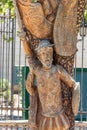 Detail of the statue of Don Quixote carved in the trunk of a tree. The text is a part of the book by Don Miguel de Cervantes, Don