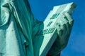Detail Of Statue Of Liberty Against Blue Sky, Book With The Date Of USA\`s Independence. New York City , United States