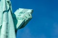 Detail of Statue of Liberty against blue sky, book with the date of USA`s independence. New York City , United States Royalty Free Stock Photo