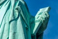 Detail of Statue of Liberty against blue sky, book with the date of USA`s independence. New York City , United States Royalty Free Stock Photo