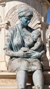 Detail of statue representing the life of Alexander the great,including his mother with baby in her arms on sunny day, monument in