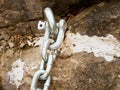 Detail of steel bolt anchor eye in sandstone roc hold steel chain. Royalty Free Stock Photo