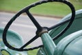 Detail of the steering wheel on an old fashioned metal tractor