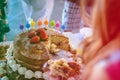 detail of strawberry and meringue naked cake, seen from above, 3 stories high. Translation of candles mean congratulations. Co Royalty Free Stock Photo