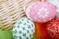 Detail of strawy basket with Easter eggs and velvet Royalty Free Stock Photo