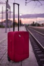 Detail of suitcase near the train tracks at sunrise