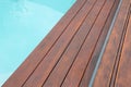 Detail of swimming pool coping and cover constructed by cumaru wood deck, hardwood decking texture next water