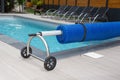 Detail swimming pool cover for protection and heat the water with wheels Royalty Free Stock Photo