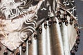 Detail of a taupe raw silk drapery with beads Royalty Free Stock Photo