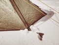 Detail of tent nylon strap anchored into snow. Camping in wild nature