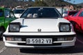 Detail of the third-generation white Honda Prelude old Japanese sports car, with folding headlights.