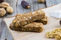 Detail on a Dates bar with walnuts and coconut on a wooden board