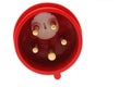 Detail of three phase electric plug connector, red plastic shell, white background