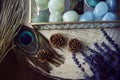 Detail of three pineapples on a wooden trunk next to a glass jewelry box with semiprecious stones in green and turquoise tones. Royalty Free Stock Photo