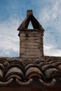 Detail of tiled roof and brick chimney from the town of San Costanzo Royalty Free Stock Photo