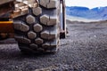 Detail on tire track pattern on a yellow heavy duty digger excavator