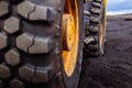 Detail on tire track pattern on a yellow heavy duty digger excavator Royalty Free Stock Photo