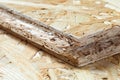 Detail of tongue and groove chip board lying on top of chip board. Blurred background