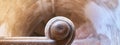 Top view of a stone spiral staircase with a wooden railing Royalty Free Stock Photo