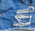 Detail of torn blue denim, front view Royalty Free Stock Photo