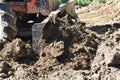 Tractor push clot soil after pour from truck