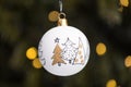 Detail of a traditional Christmas flask hanging on a tree