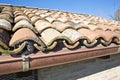 Detail of a traditional italian roof viewed from above made with terracotta roof tiles with copper gutter Royalty Free Stock Photo