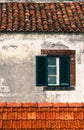 Detail from traditional old Portuguese facade with green and white wooden window