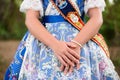 Detail of a traditional Valencian fallera dress, with beautiful embroidery, crossed hands