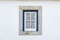 Detail of a traditional window on a white facade of a house