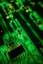 Detail of a transistor array, resistors and capacitors soldered to a green glowing PCB Royalty Free Stock Photo