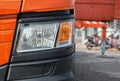 Detail of a truck. A fragment of a large commercial semi truck with modern design of headlights