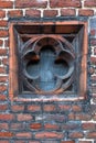 Detail of Tudor architecture exterior rose-shaped wall window slit Royalty Free Stock Photo