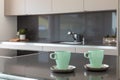 Detail of two breakfast cups in a modern and design kitchen