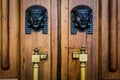 Sphinx heads entrance on wooden door Royalty Free Stock Photo