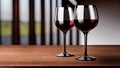 Detail of two clear crystal glasses of red wine on a dark wooden table