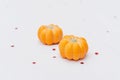 Detail of two pumpkin chocolate bonbon with sparkling red stars. Halloween goodies. Selective focus