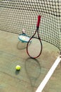 Detail of two tennis rackets and balls by the net at an outdoor tennis court Royalty Free Stock Photo