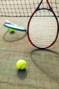 Detail of two tennis rackets and balls by the net at an outdoor tennis court, selective focus Royalty Free Stock Photo