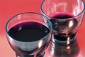 Two glasses of wine with red backgr Royalty Free Stock Photo