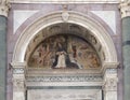 Detail in the tympanum above the central front door of the facade of the Basilica Santa Maria Novella in Florence.