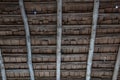 Detail of the underside of a porch roof on an old log cabin with pole beams and wood shingles Royalty Free Stock Photo