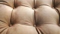 Detail of upholstery of modern furniture, chair, armchair, pouf or pillow. Carriage coupler. Brown nature color. Premium luxury Royalty Free Stock Photo