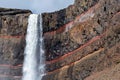 Detail of the upper part of waterfall Hengifoss with colored cliff in eastern Iceland