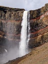 Detail of the upper part of waterfall Hengifoss with colored cliff in eastern Iceland