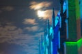 detail view of ancient roman catholic basilica in germany at night with cloudy sky and full moon Royalty Free Stock Photo