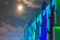 detail view of ancient roman catholic basilica in germany at night with cloudy sky and full moon Royalty Free Stock Photo