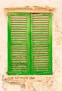 Old green wood window shutter of mediterranean house Royalty Free Stock Photo